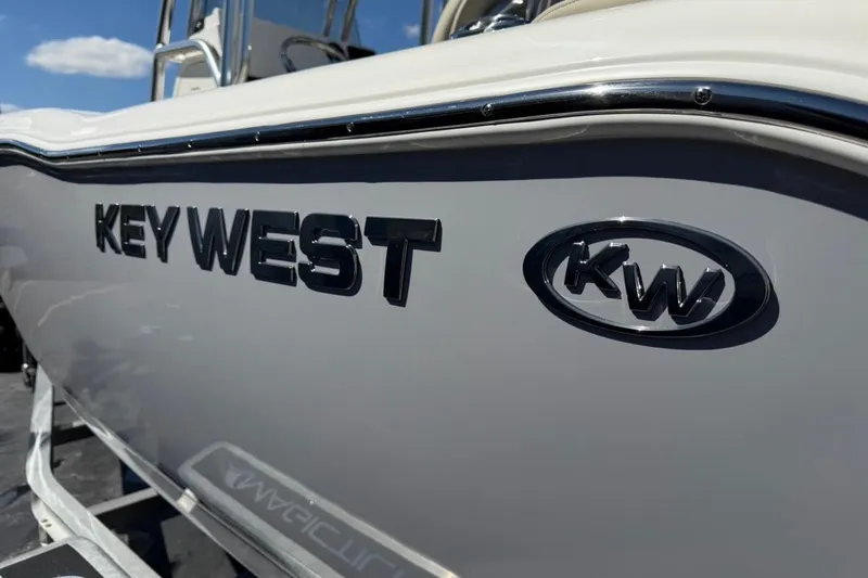 Slide: The Image of 2026 Key West 203 FS boat with logo, side view under clear sky. - 46