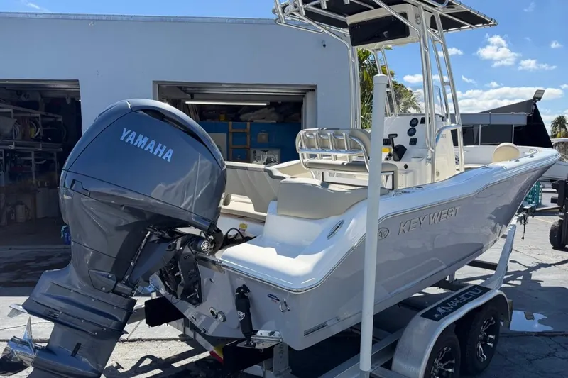 Slide: The Image of 2026 Key West 203 FS boat with Yamaha engine on trailer, parked outdoors. - 6
