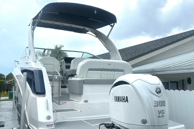 Slide: The Image of 2025 Regal 26 XO boat with Yamaha 300 V6 engine, docked near a house. - 11