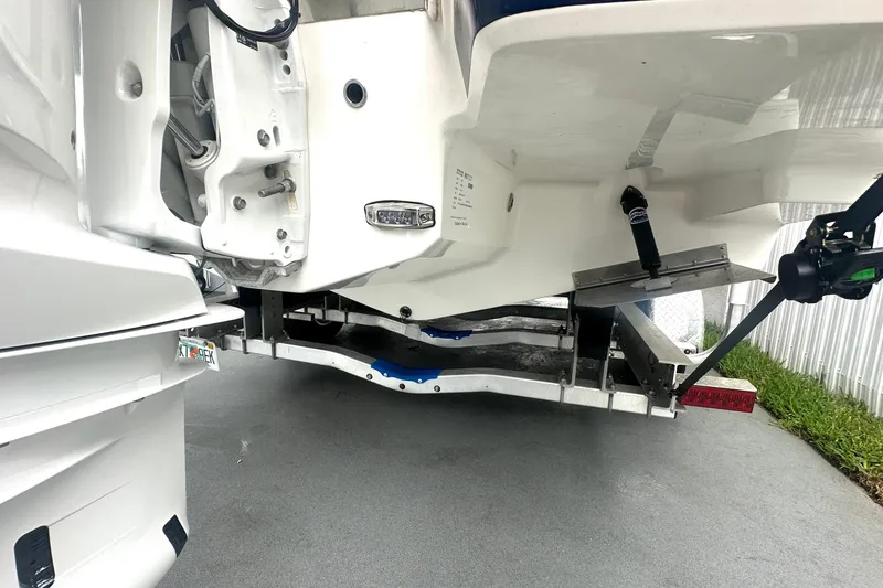 Slide: The Image of 2025 Regal 26 XO boat trailer view, showcasing the underside and mechanical components. - 22