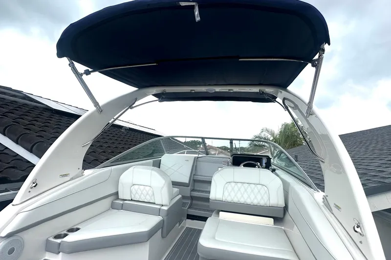 Slide: The Image of 2025 Regal 26 XO boat interior with white seating and canopy, showcasing modern design. - 24