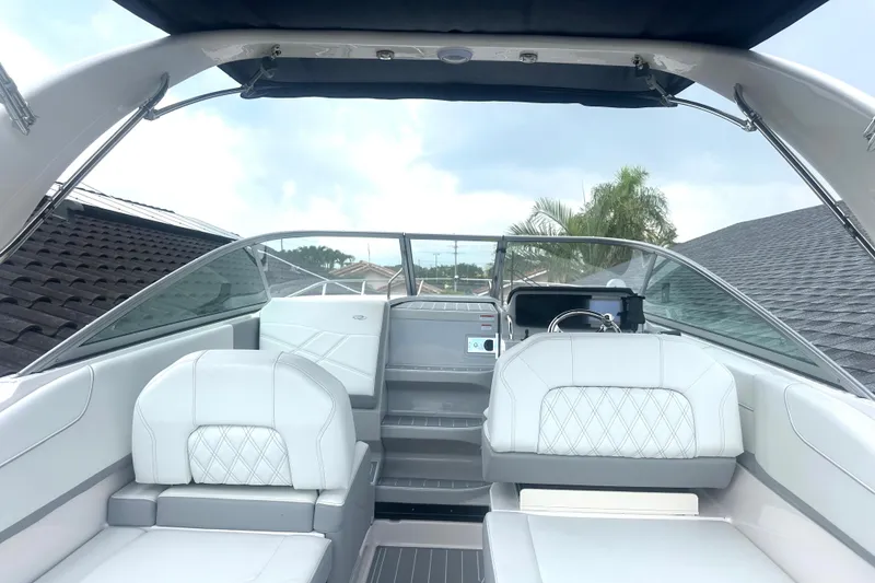 Slide: The Image of 2025 Regal 26 XO boat interior with white seating and modern dashboard. - 25