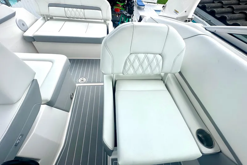 Slide: The Image of 2025 Regal 26 XO boat interior with white cushioned seating and sleek flooring. - 29