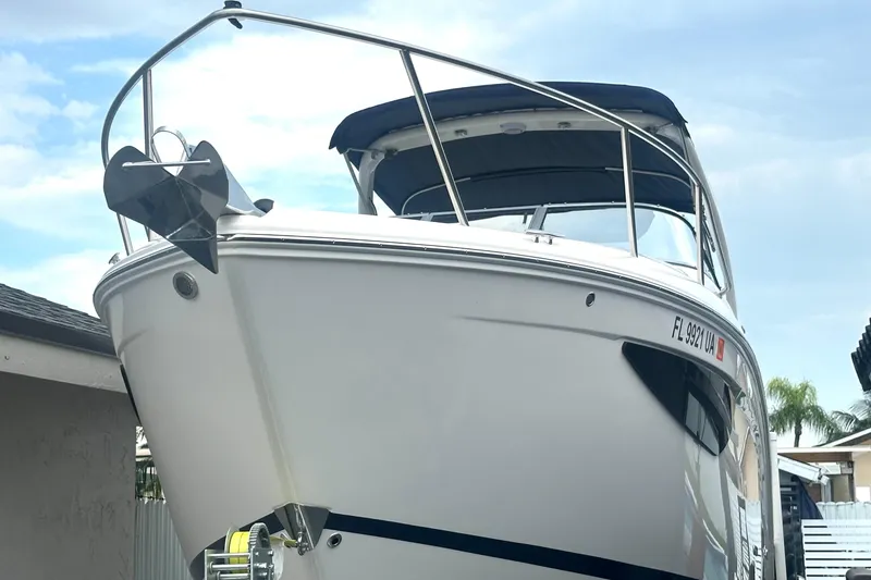 Slide: The Image of 2025 Regal 26 XO boat with sleek design, docked under a clear sky. - 3