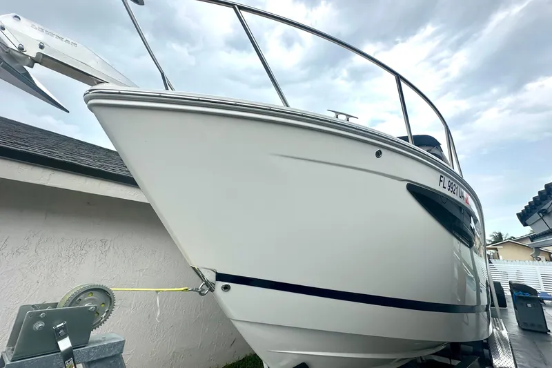 Slide: The Image of 2025 Regal 26 XO boat on trailer, side view under cloudy sky. - 4