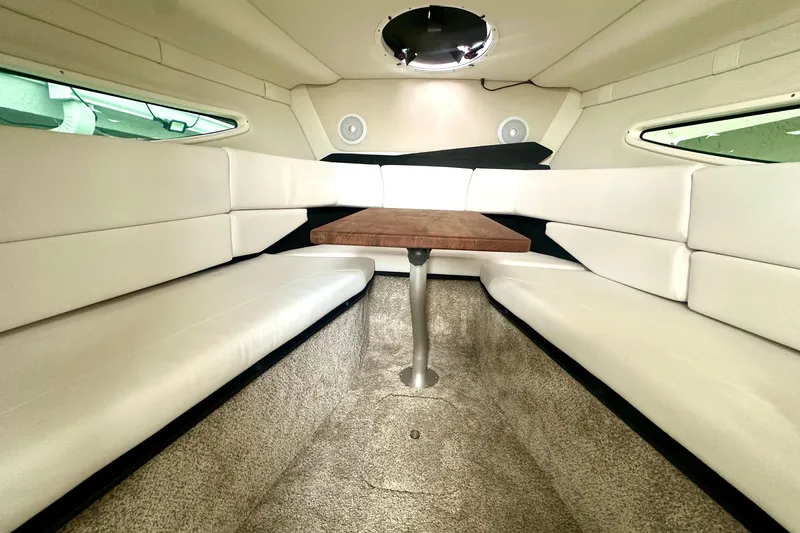 Slide: The Image of Interior of 2025 Regal 26 XO boat with plush seating and wooden table. - 41