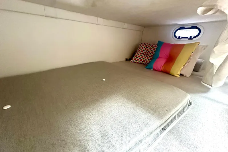 Slide: The Image of Cozy cabin interior of 2025 Regal 26 XO boat with colorful pillows and window. - 50