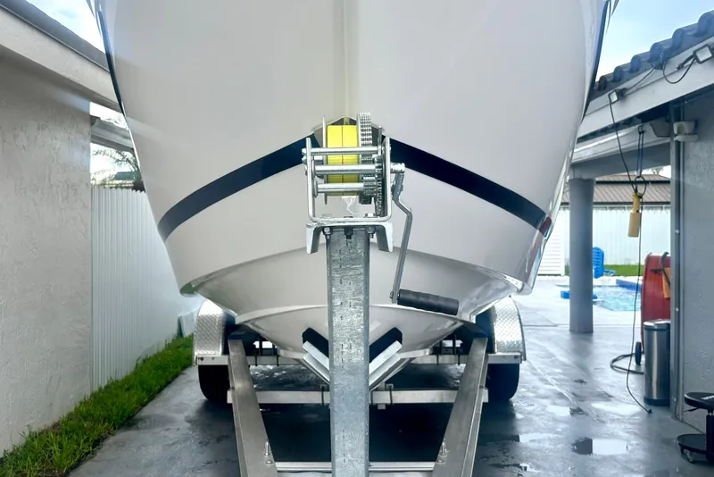 Slide: The Image of 2025 Regal 26 XO boat on trailer in driveway, front view. - 7