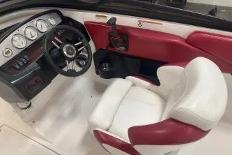 Slide: The Image of 2008 Regal 2000 Bowrider interior with red and white seating, steering wheel, and dashboard. - 11