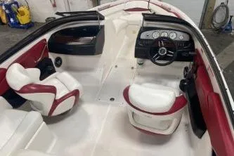 Slide: The Image of 2008 Regal 2000 Bowrider interior with red and white seating and dashboard. - 12