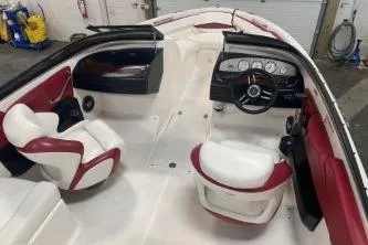 Slide: The Image of 2008 Regal 2000 Bowrider interior with red and white seating, steering wheel, and dashboard. - 13