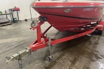 Slide: The Image of Red 2008 Regal 2000 Bowrider boat on trailer in garage setting. - 16