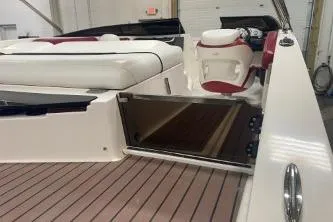 Slide: The Image of 2008 Regal 2000 Bowrider interior with white and red seating, open storage compartment. - 18