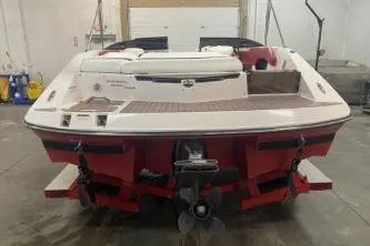 Slide: The Image of 2008 Regal 2000 Bowrider boat in a garage, rear view, red and white design. - 5