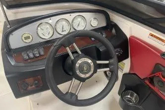 Slide: The Image of Steering wheel and dashboard of 2008 Regal 2000 Bowrider boat with gauges and controls. - 6