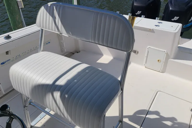 Slide: The Image of 2006 Sea Fox 287 Center Console boat interior with white cushioned seating. - 13