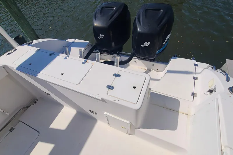 Slide: The Image of 2006 Sea Fox 287 Center Console boat with dual outboard motors, docked on water. - 15