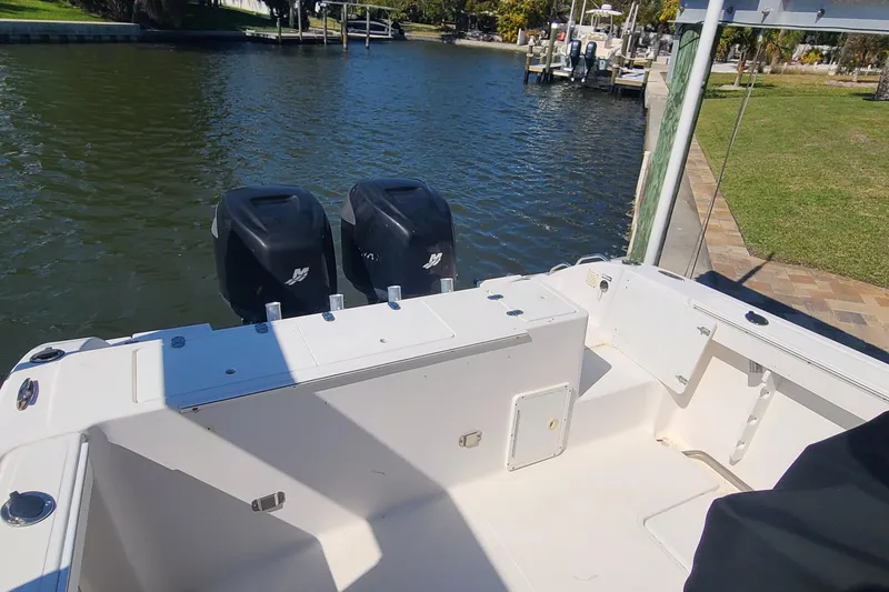 Slide: The Image of 2006 Sea Fox 287 Center Console boat with dual outboard motors docked by the water. - 17