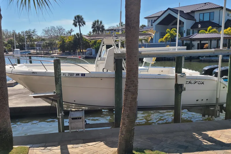 Slide: The Image of 2006 Sea Fox 287 Center Console boat docked near waterfront homes. - 2