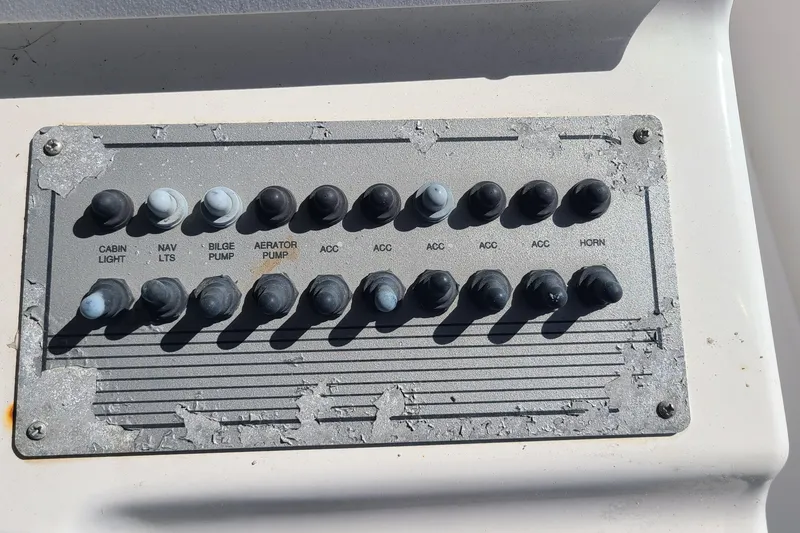 Slide: The Image of Control panel of a 2006 Sea Fox 287 Center Console boat with various switches. - 9