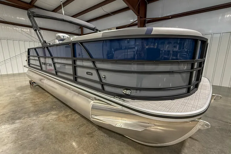Slide: The Image of 2025 Trifecta 22UL CS pontoon boat in a spacious indoor showroom. - 10