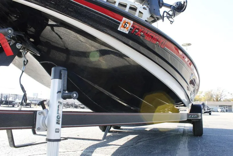 Slide: The Image of 2022 Skeeter ZXR21 boat on trailer, close-up view of hull and trailer components. - 13