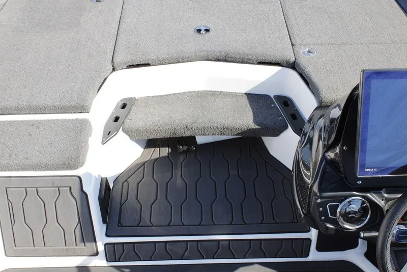 Slide: The Image of 2022 Skeeter ZXR21 boat interior with carpeted deck and control panel. - 16