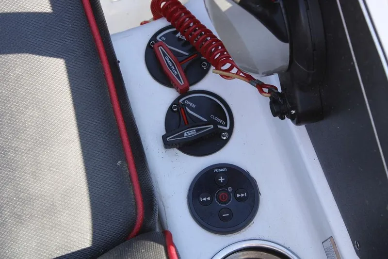 Slide: The Image of Control panel of a 2022 Skeeter ZXR21 boat with switches and audio controls. - 28