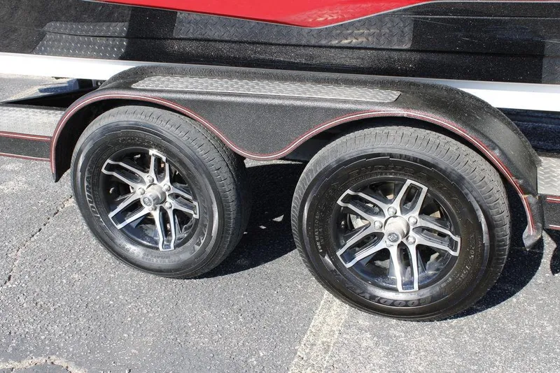 Slide: The Image of 2022 Skeeter ZXR21 trailer with dual black alloy wheels on asphalt. - 3