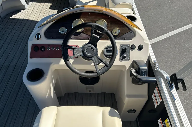 Slide: The Image of 2022 Lexington 317 series boat dashboard with steering wheel and control panel. - 11