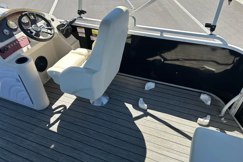 Slide: The Image of 2022 Lexington 317 series boat interior with steering console and seating. - 13