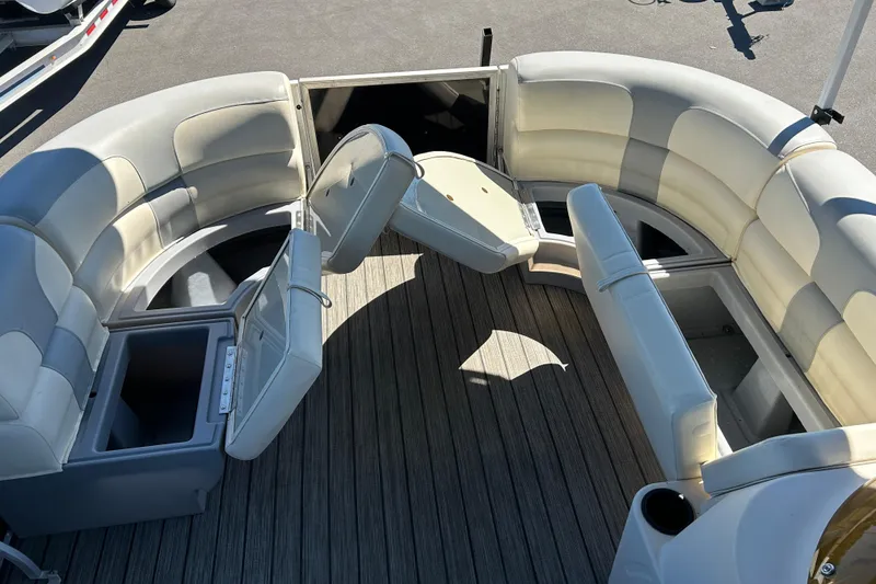 Slide: The Image of 2022 Lexington 317 series boat interior with open storage compartments and cushioned seating. - 14