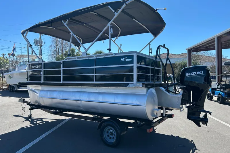 Slide: The Image of 2022 Lexington 317 series pontoon boat with Suzuki outboard motor on trailer. - 4