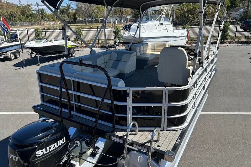 Slide: The Image of 2022 Lexington 317 series pontoon boat with Suzuki 70 engine, parked outdoors. - 7