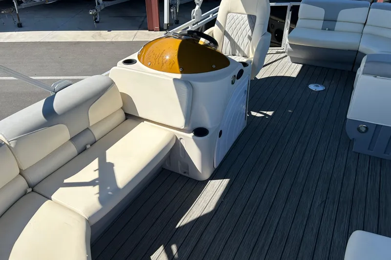 Slide: The Image of 2022 Lexington 317 series boat interior with beige seating and steering console. - 9