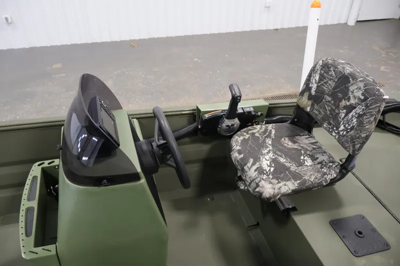 Slide: The Image of 2025 Alweld 1648 Marsh boat interior with camo seat and steering console. - 15