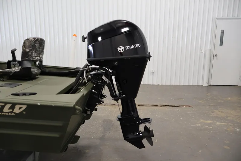 Slide: The Image of 2025 Alweld 1648 Marsh boat with Tohatsu outboard motor in a garage setting. - 23