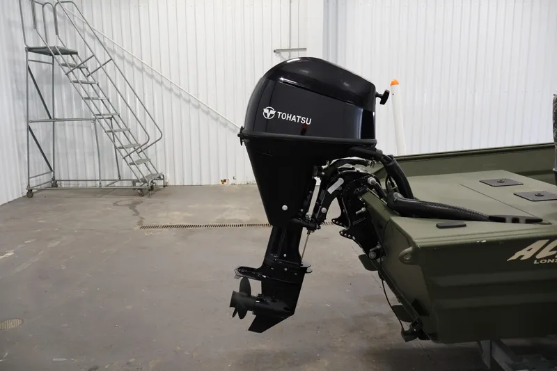 Slide: The Image of 2025 Alweld 1648 Marsh boat with Tohatsu outboard motor in a garage setting. - 24