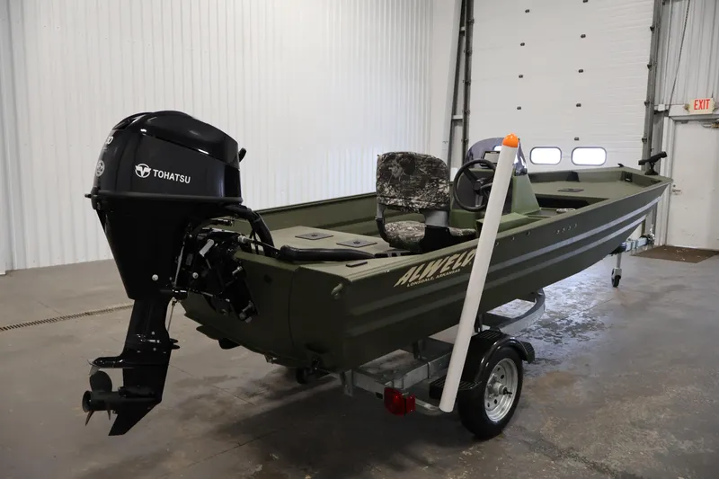 Slide: The Image of 2025 Alweld 1648 Marsh boat with Tohatsu motor in a garage setting. - 4