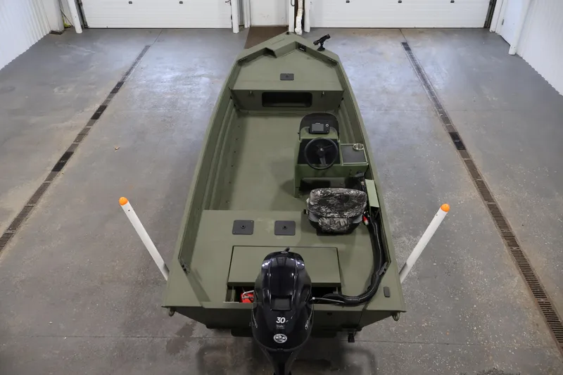 Slide: The Image of 2025 Alweld 1648 Marsh boat in a garage, featuring a 30 HP motor. - 9