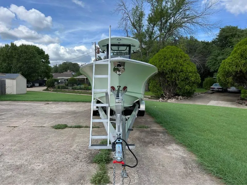 Slide: The Image of 2022 Sea Hunt Gamefish 27 boat on trailer, parked in a driveway. - 17