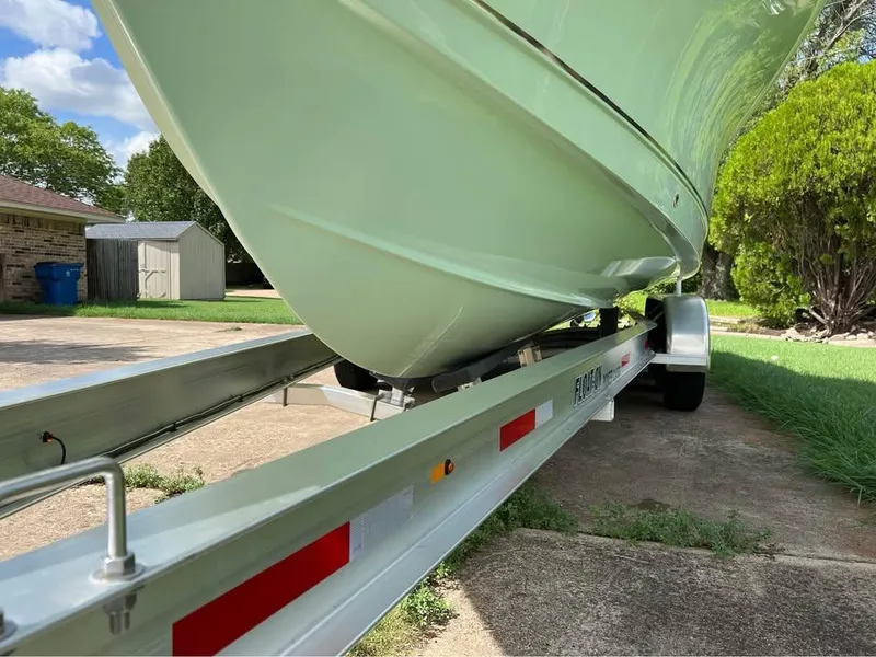 Slide: The Image of 2022 Sea Hunt Gamefish 27 on trailer, parked in driveway, side view. - 18