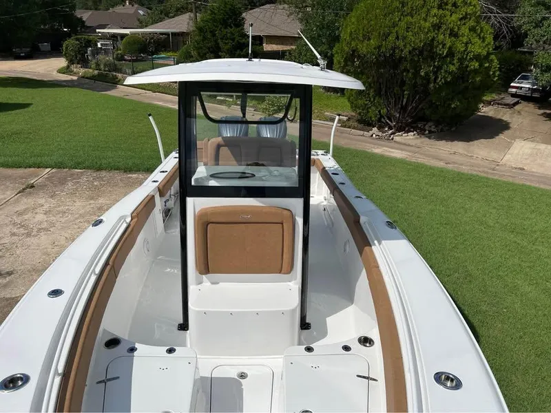 Slide: The Image of 2022 Sea Hunt Gamefish 27 boat with center console, parked on a driveway. - 7