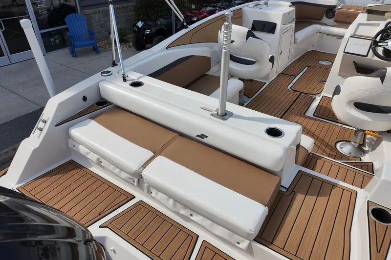 Slide: The Image of 2023 Starcraft SVX 231 OB boat interior with stylish seating and wood-patterned flooring. - 11