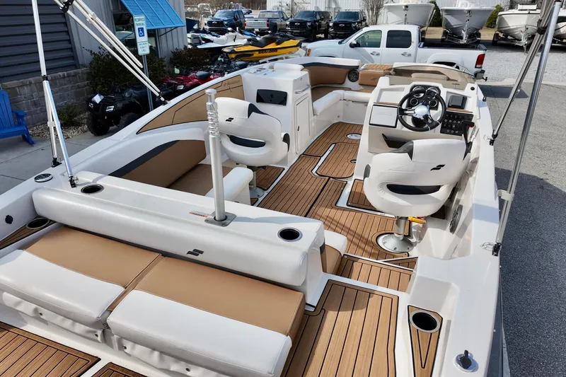 Slide: The Image of 2023 Starcraft SVX 231 OB boat interior with modern seating and steering console. - 12