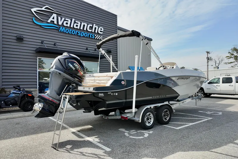 Slide: The Image of 2023 Starcraft SVX 231 OB boat on trailer at Avalanche Motorsports dealership. - 17