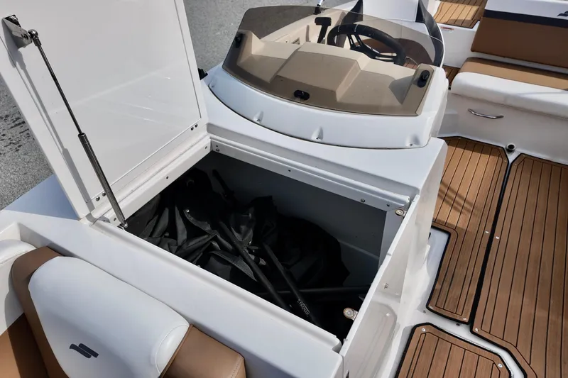 Slide: The Image of 2023 Starcraft SVX 231 OB boat with open storage compartment and teak flooring. - 4