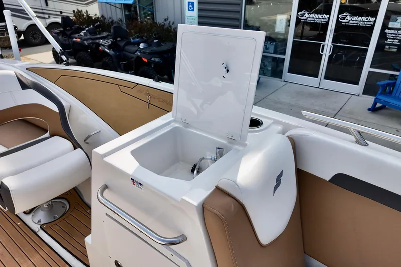 Slide: The Image of 2023 Starcraft SVX 231 OB boat interior with sink and seating area. - 5