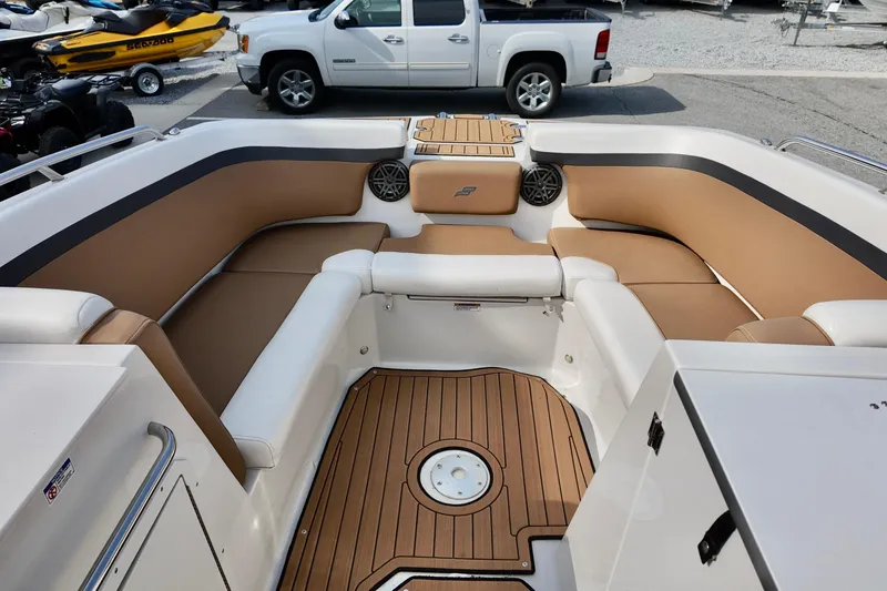 Slide: The Image of 2023 Starcraft SVX 231 OB boat interior with tan seating and wood-style flooring. - 9