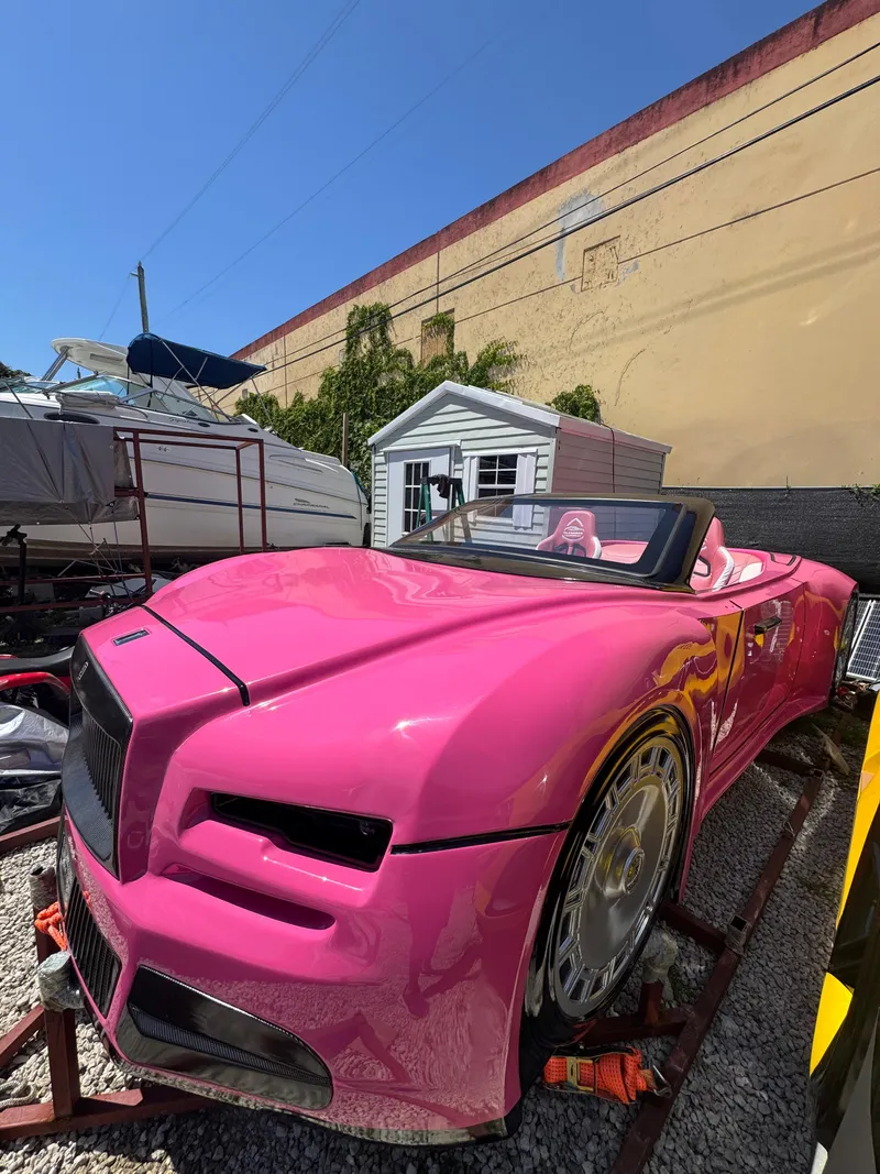 Slide: The Image of A vibrant pink 2025 Fabbro Jet Car RR parked outdoors on a sunny day. - 10